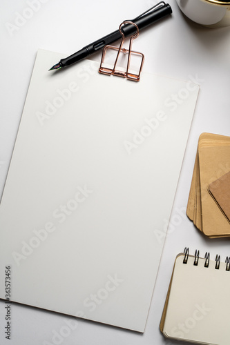 Clipboard with golden clip, fountain pen and plants on desk.  Branding stationery mockup. Corporate modern items set
