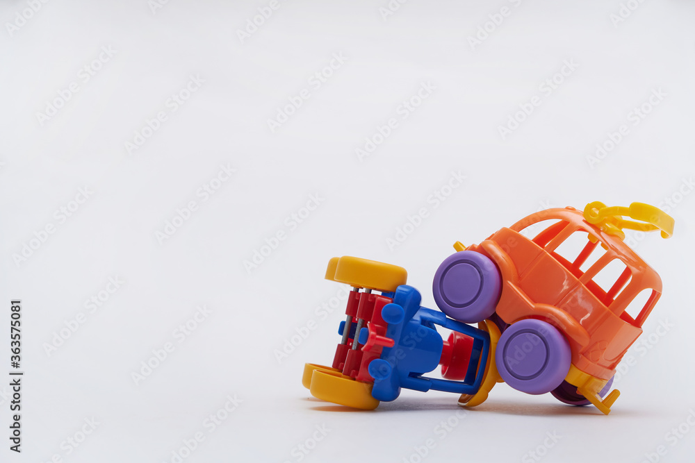toy cars collided in an accident on a white background Crash on a toy road