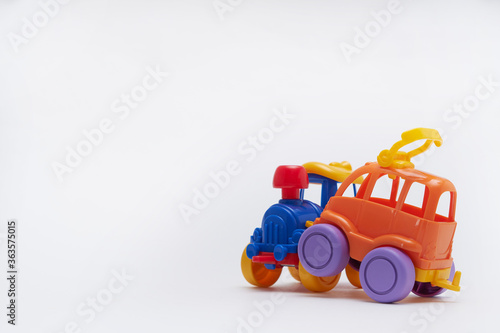 Colored toy cars collided in an accident on a white background Crash on a toy road