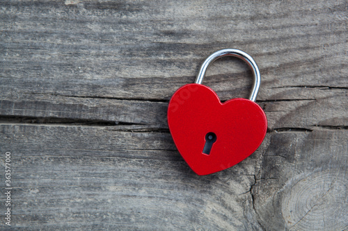 heart shaped padlock on wooden background