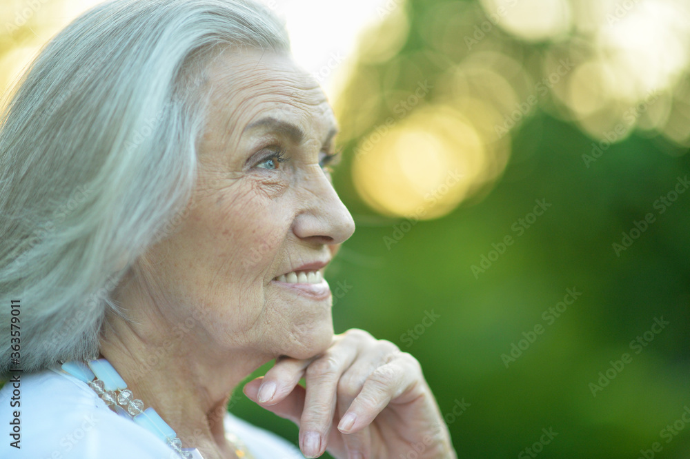 Close up portrait of beautiful smiling senior woman in spring park Close up portrait of beautiful smiling senior woman in spring park