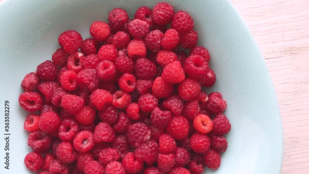 Juicy fresh raspberries with water drops in motion. beautiful bokeh Juicy fresh raspberries with water drops in motion. beautiful bokeh