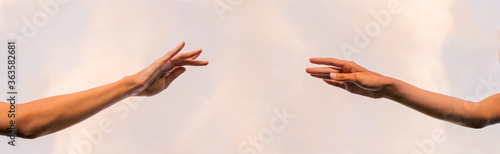 Banner. Two thin graceful female hands stretch towards each other.