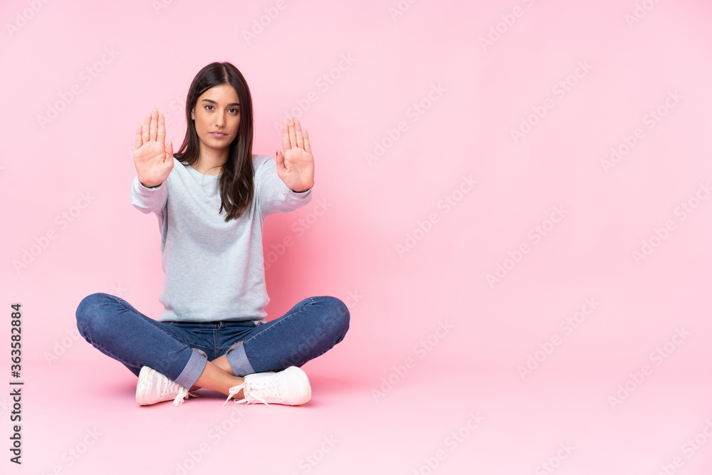 Young caucasian woman isolated on pink background making stop gesture and disappointed Young caucasian woman isolated on pink background making stop gesture and disappointed