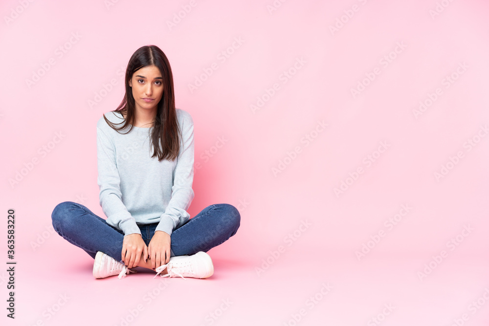 Young caucasian woman isolated on pink background with sad and depressed expression Young caucasian woman isolated on pink background with sad and depressed expression