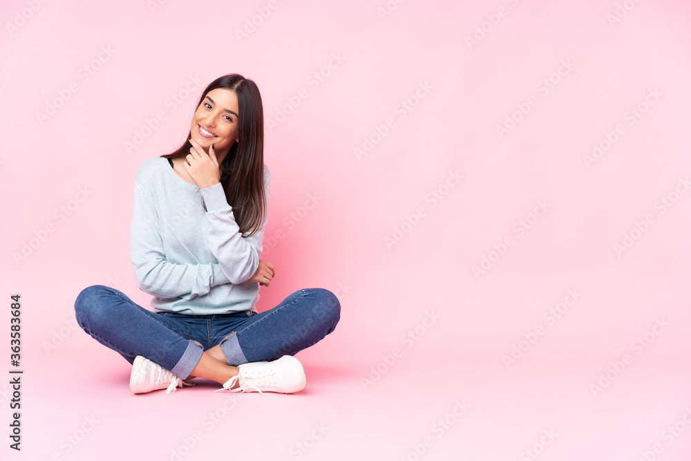 Young caucasian woman isolated on pink background smiling