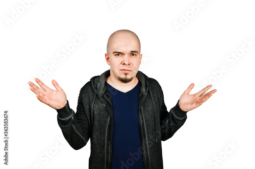 Canvas Print Confused young bald man with alopecia shrugs, isolated on white background