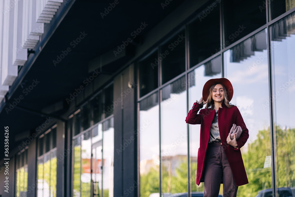 Fototapeta premium young elegant fashionable business woman wearing trendy coat nea
