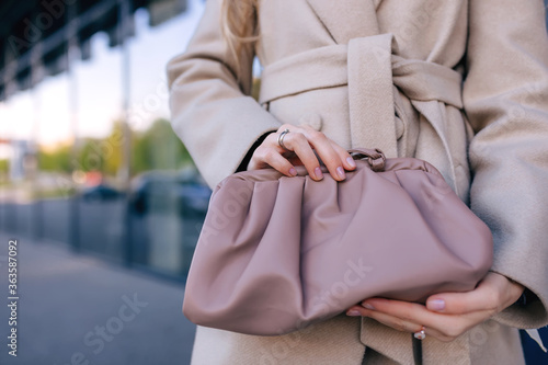 Elegant little leather bag in the hands of a fashionista.