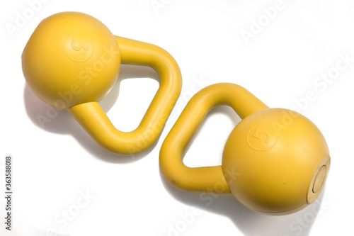 Couple yellow kettle bell on white background