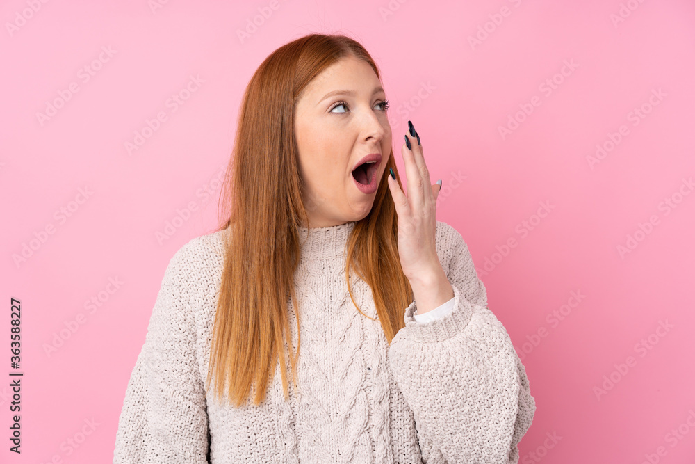 Young redhead woman over isolated pink background yawning and covering wide open mouth with hand Young redhead woman over isolated pink background yawning and covering wide open mouth with hand
