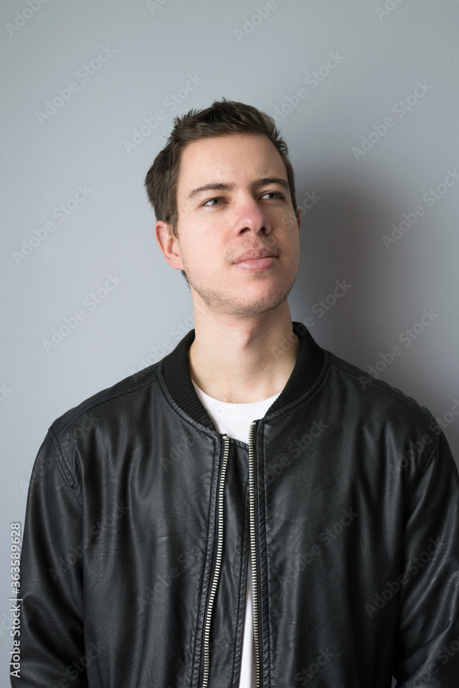 Portrait of a modern young man in leather jacket looking to the side Portrait of a modern young man in leather jacket looking to the side