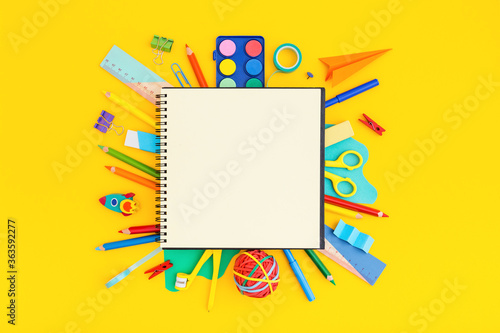 School notebook with school supplies on grid background. Back to school. Elementary school concept. 
