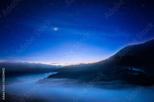 Fantastic night sky over mountains. © YouraPechkin