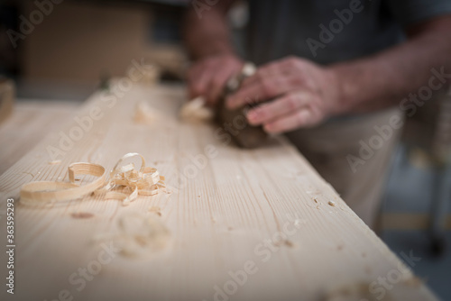 man work on a table, wood work, handmade work, traditional italian artisan