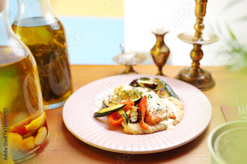 Salmon with grilled vegetables on vegetable puree.
Appetizing dish. Suggestion of serving a dish. Culinary photography. photo