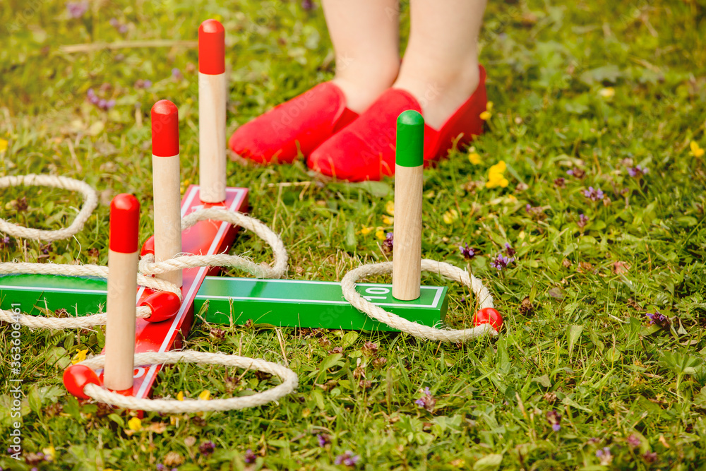 Close up view of ring pole tossing game outdoors in home garden, summer day. Family garden play time concept.