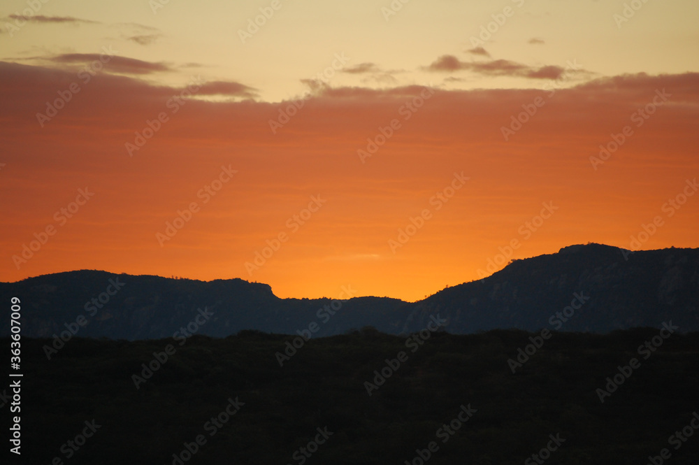 Sunset over the hills of the Brazilian Northeast with an orange sky