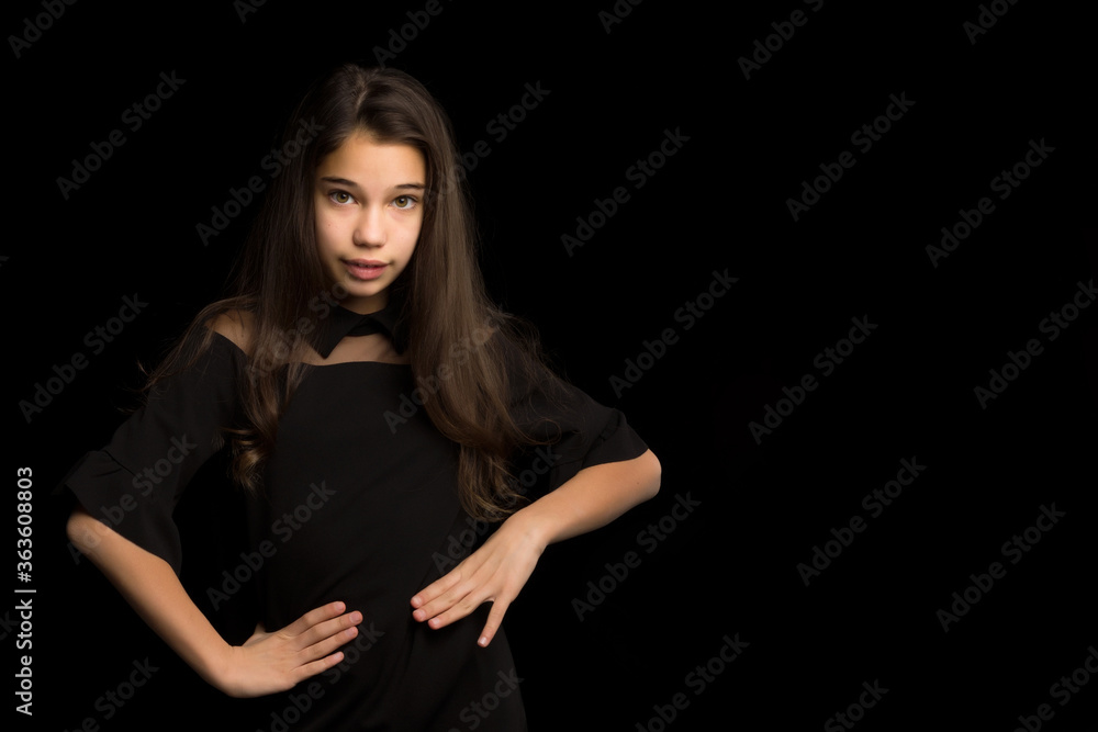 Close-up.Portrait of a cute little girl on a black background. Close-up.Portrait of a cute little girl on a black background.
