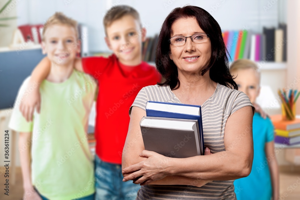 Smile woman teacher with books on student background Smile woman teacher with books on student background