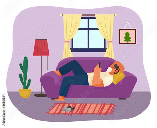 Man using phone lying on sofa or couch at home. Guy relaxing with smartphone lying on pillow. Man tired from quarantine self-isolation at home. Person wasting time in internet, have recreation