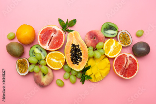 Summer fruits backround. Various fruits on pink background. Summer concept. Flat lay.