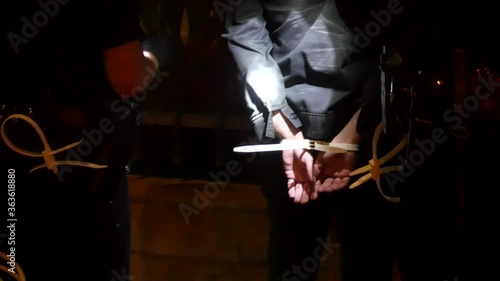 2020 - A black man is detained by police and has hands tied at Black Lives Matter BLM march in Los Angeles following the murder.