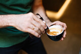 Barista pouring latte art into the cup