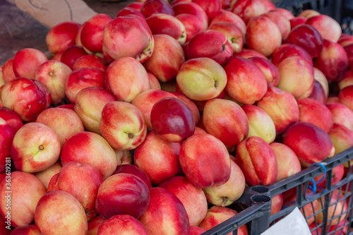 Fresh and tasty natural peach in a market stall