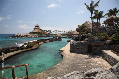 A scenic view of nature park  Xcaret with rocks and ocean under blue sky in playa del carmen Mexico