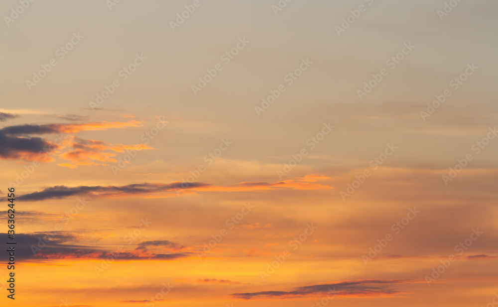 Sunset. Fuzzy cloud outlines in orange haze. Natural background.