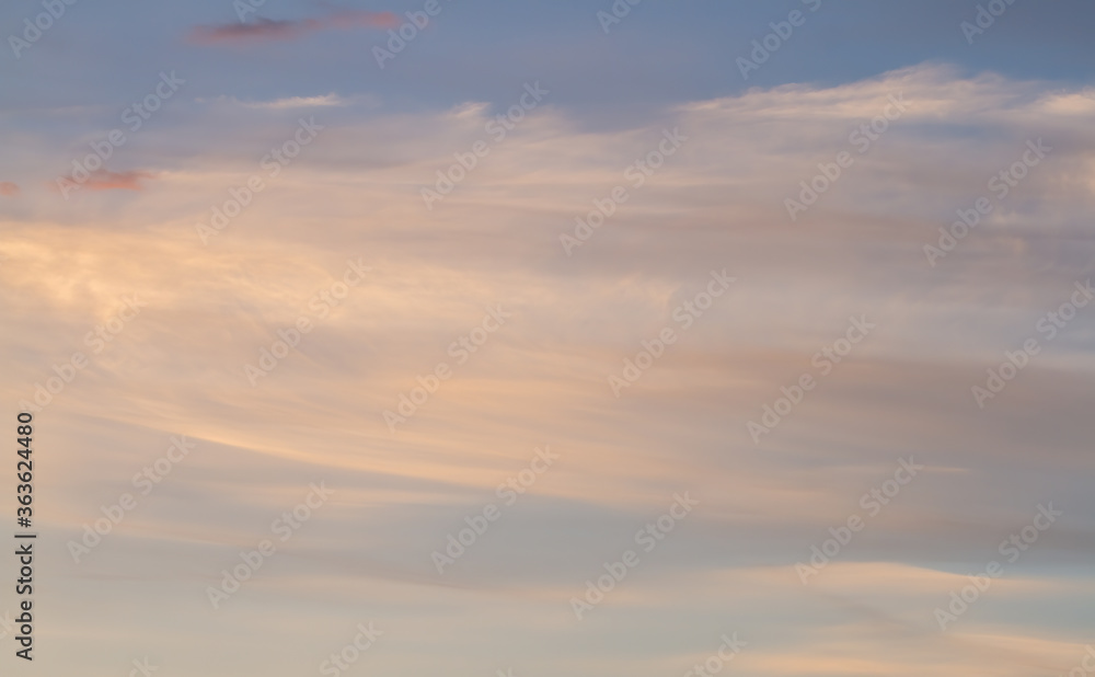 Delicate blurred shroud of clouds on a blue sky. Sunset.