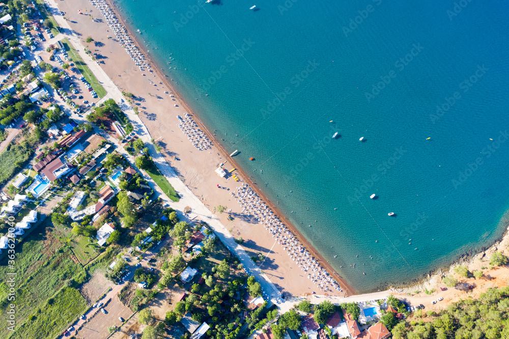 Long beach coast, dark teal sea and bay in Adrasan village Mediterranean coast, great place for holiday. background mountains and forest. Aerial view with drone. Antalya, TURKEY