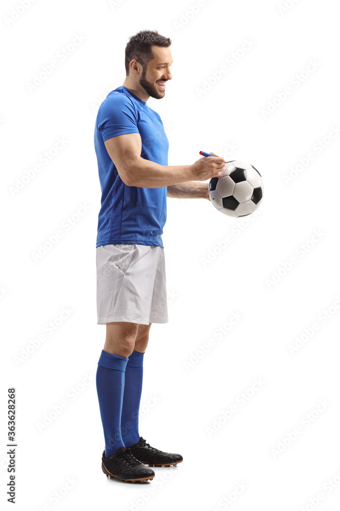 Athlete signing his autograph on a soccer ball