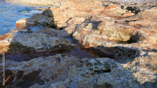 close-up of rocks at sea with water flowing over it