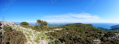 Panaroma of greek landscape on mountain with path and blue sky