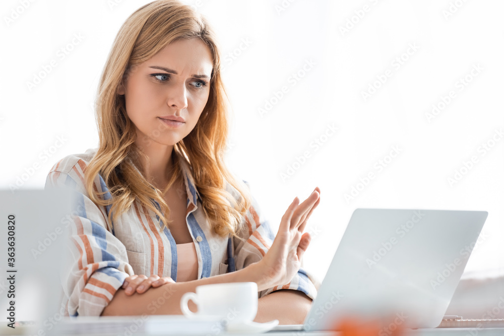 Selective focus of confused woman showing stop gesture Selective focus of confused woman showing stop gesture