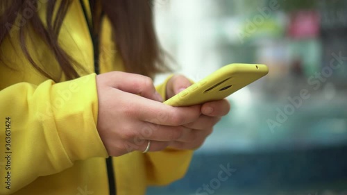 close-up young business woman college university student typing smartphone at street, female hands typing smartphone keyboard studying working furlough sending message writing notes photo