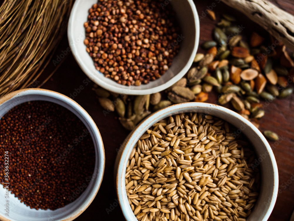 Traditional whole foods, grains, nuts and seeds in rustic, natural light setting with custom made cermics. Traditional whole foods, grains, nuts and seeds in rustic, natural light setting with custom made cermics.