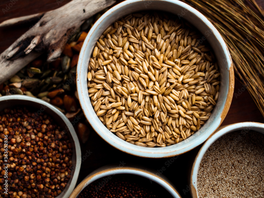 Traditional whole foods, grains, nuts and seeds in rustic, natural light setting with custom made cermics. Traditional whole foods, grains, nuts and seeds in rustic, natural light setting with custom made cermics.