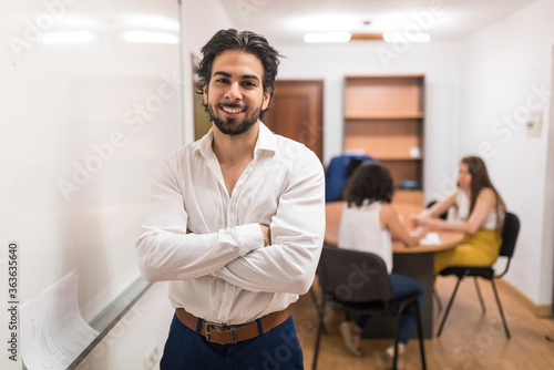 Office worker near to board with people in background