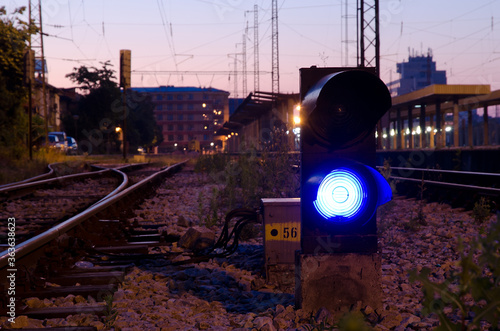 Railway signal with blue light with railroad junction