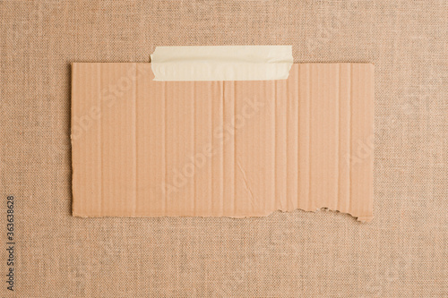 Texture or background of brown sackcloth and piece of cardboard with empty space