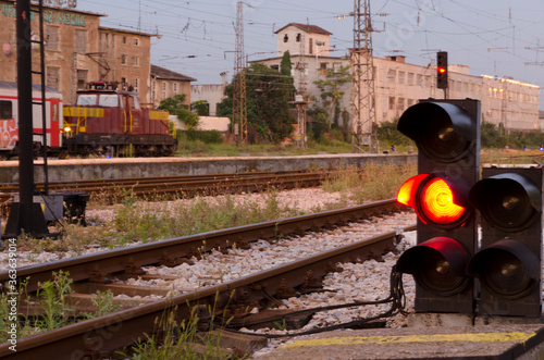 Railway signal with red light with railroad junction