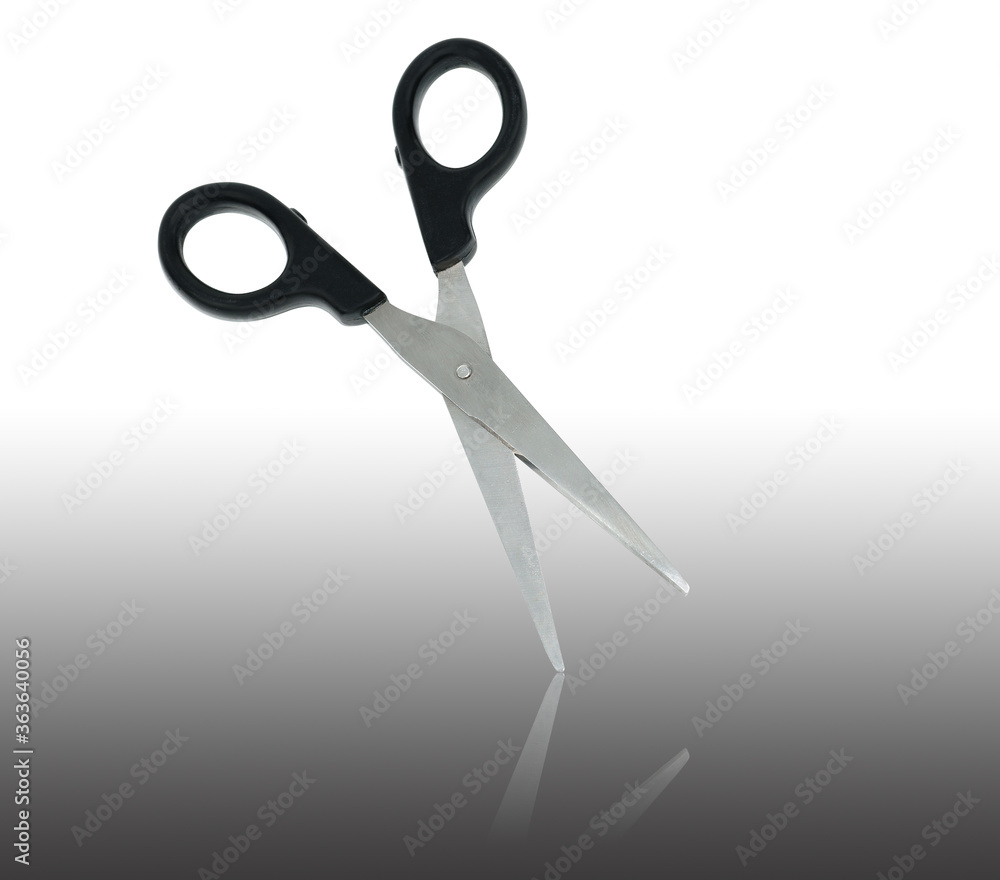 scissors with black handle and mirror reflection on a white background in isolation scissors with black handle and mirror reflection on a white background in isolation