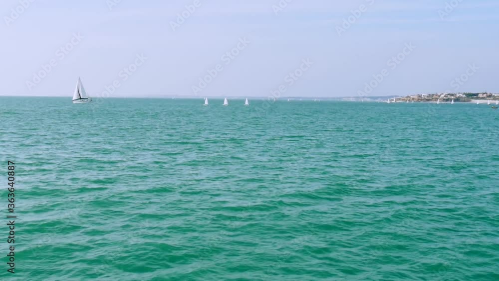 bay with sailboats sailing on a calm sea bay with sailboats sailing on a calm sea