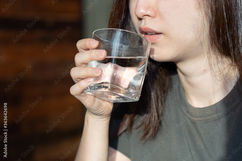 Asian Woman Drinking Water With a Glass Asian Woman Drinking Water With a Glass