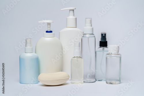group of hand sanitizer spray and liquid soap bottles isolated on white background