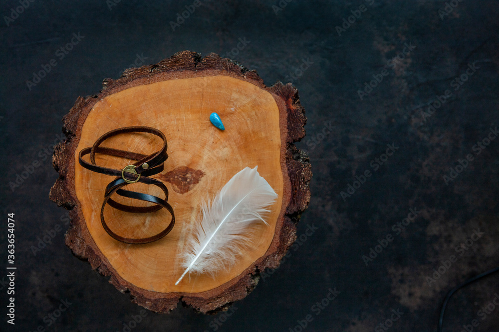 Leather bracelet, white bird feather and mineral. Fortune telling, magic and other ritual items Leather bracelet, white bird feather and mineral. Fortune telling, magic and other ritual items