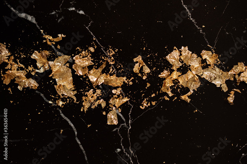 gold leaf petals on black marble photo